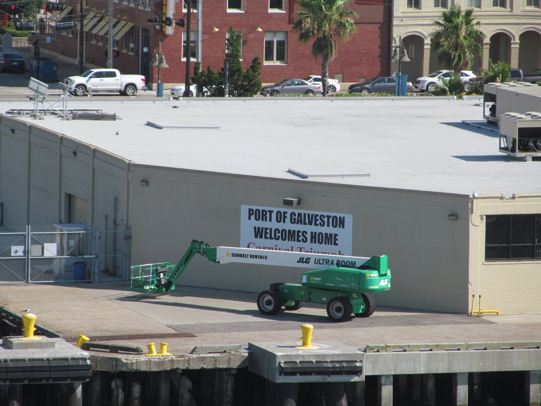 Banner on side of Cruise terminal that says Port of Galveston Welcomes Home Carnival Triumph