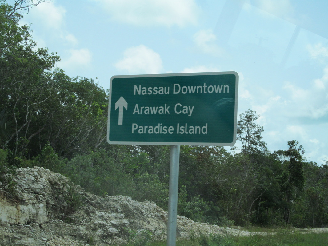 Road Sign Pointing To Downtown and Paradise Island