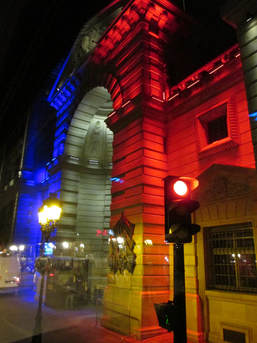 Police station lit by colors of French flag 