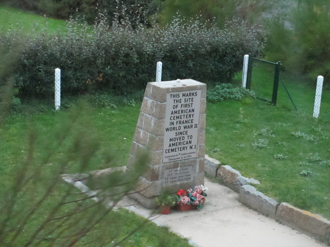 Marker along beach road for first American cemetery in France